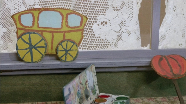 Wide shot frame from In the Mouth of Madness — train, wheel, grapefruit