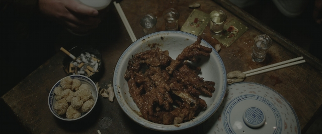 Wide shot frame from Joy Ride — plate, table, food