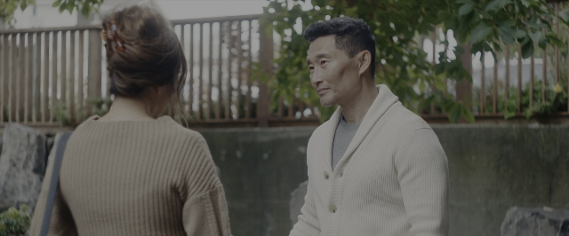 Wide shot frame from Joy Ride — standing, dialogue, bag