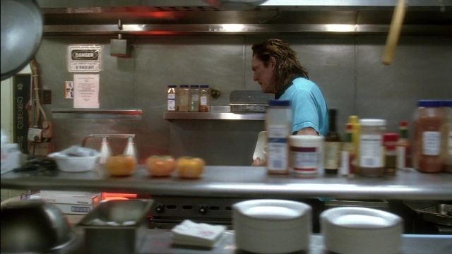 Wide shot frame from Kill Bill: Vol. 2 — kitchen, food, shirt