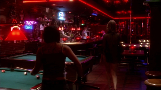 Wide shot frame from Kill Bill: Vol. 2 — sitting, standing, table