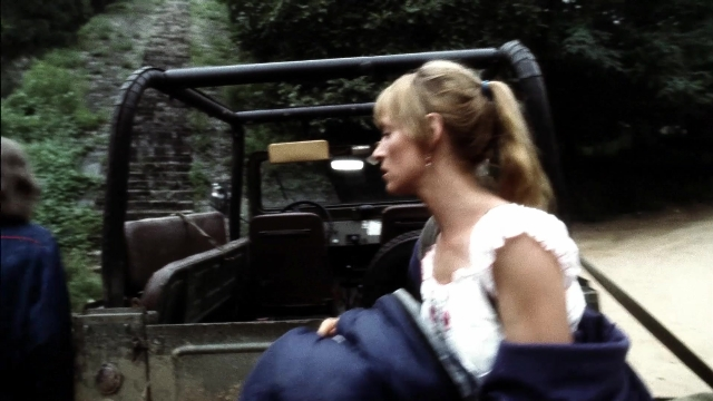 Wide shot frame from Kill Bill: Vol. 2 — sitting, street, face