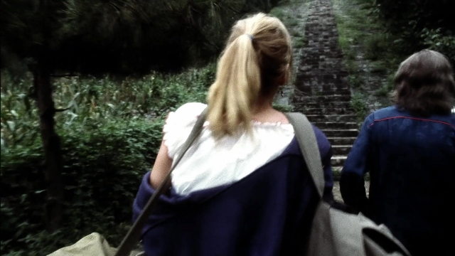 Wide shot frame from Kill Bill: Vol. 2 — walking, dress, bag
