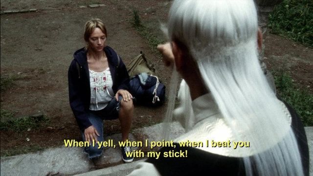 Wide shot frame from Kill Bill: Vol. 2 — sitting, hand, face