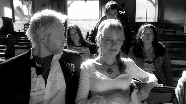 Wide shot frame from Kill Bill: Vol. 2 — sitting, suit, tie