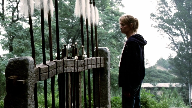 Wide shot frame from Kill Bill: Vol. 2 — standing, hair, forest