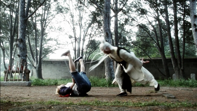 Wide shot frame from Kill Bill: Vol. 2 — standing, coat, forest