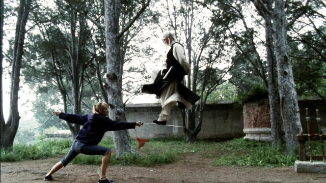 Wide shot frame from Kill Bill: Vol. 2 — standing, coat, hand