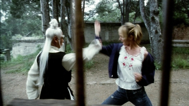 Wide shot frame from Kill Bill: Vol. 2 — hand, face, hair