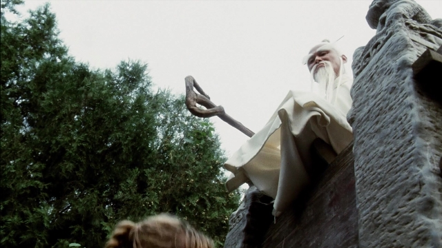 Wide shot frame from Kill Bill: Vol. 2 — sitting, hand, beard