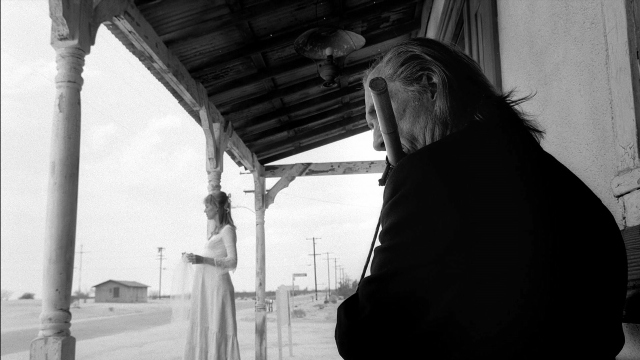 Wide shot frame from Kill Bill: Vol. 2 — standing, coat, dress