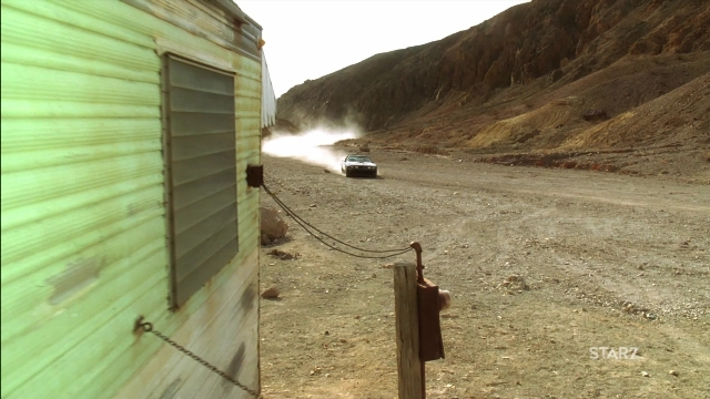 Wide shot frame from Kill Bill: Vol. 2 — street, car, smoke