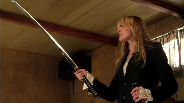 Wide shot frame from Kill Bill: Vol. 2 — standing, room, hand