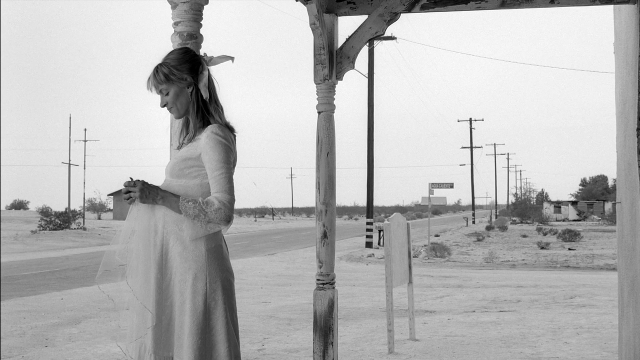 Wide shot frame from Kill Bill: Vol. 2 — standing, dress, face
