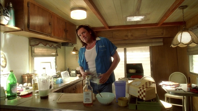 Wide shot frame from Kill Bill: Vol. 2 — standing, table, kitchen