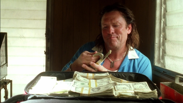 Wide shot frame from Kill Bill: Vol. 2 — sitting, table, door