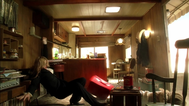 Wide shot frame from Kill Bill: Vol. 2 — sitting, room, table