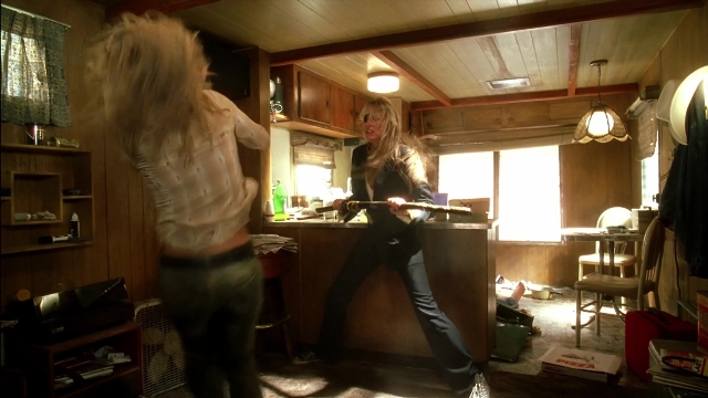 Wide shot frame from Kill Bill: Vol. 2 — standing, room, table