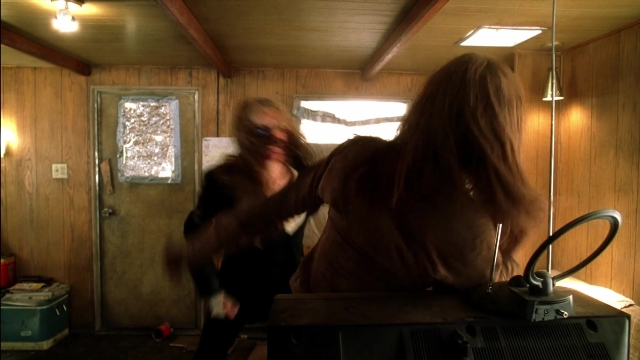 Frame from Kill Bill: Vol. 2 — standing, room, table