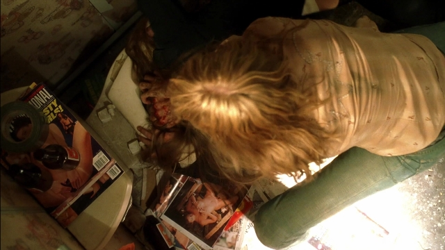 Wide shot frame from Kill Bill: Vol. 2 — table, bed, bottle