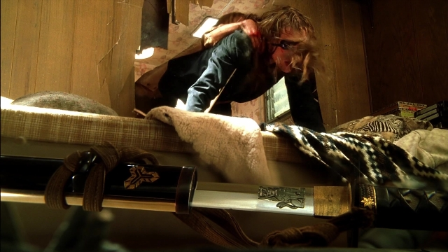 Wide shot frame from Kill Bill: Vol. 2 — room, table, bed