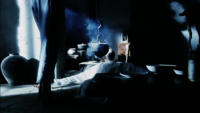 Wide shot frame from Kill Bill: Vol. 2 — room, table, bed