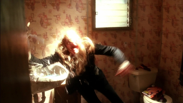 Wide shot frame from Kill Bill: Vol. 2 — hand, bathroom, hair