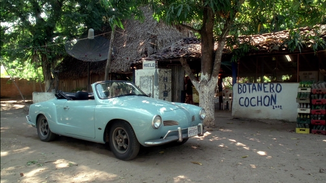 Wide shot frame from Kill Bill: Vol. 2 — street, car, restaurant