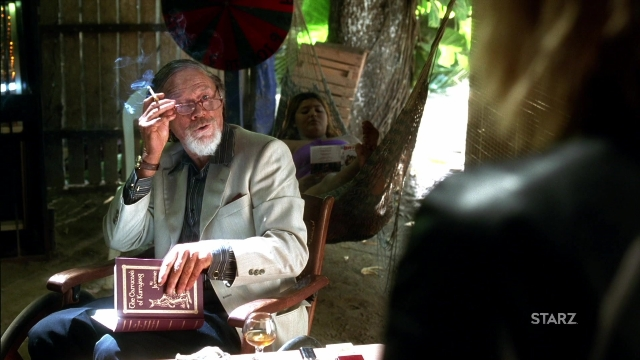 Wide shot frame from Kill Bill: Vol. 2 — sitting, book, room