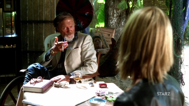 Wide shot frame from Kill Bill: Vol. 2 — sitting, book, plate