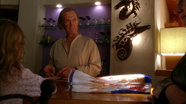 Wide shot frame from Kill Bill: Vol. 2 — sitting, table, shirt