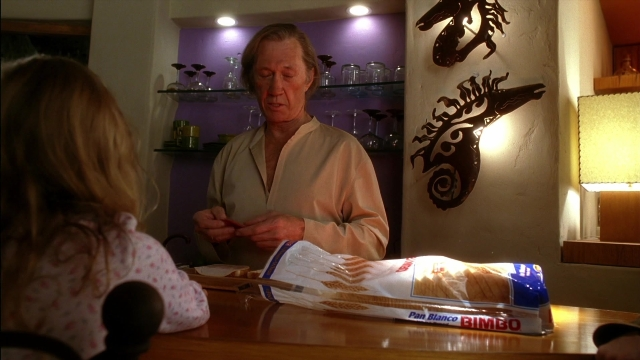 Wide shot frame from Kill Bill: Vol. 2 — sitting, table, shirt