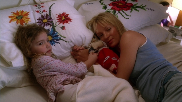 Wide shot frame from Kill Bill: Vol. 2 — bed, dress, lamp
