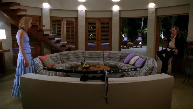 Wide shot frame from Kill Bill: Vol. 2 — sitting, standing, table