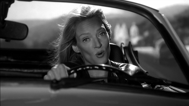 Wide shot frame from Kill Bill: Vol. 2 — sitting, mirror, car