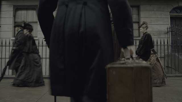 Medium shot frame from Sherlock Holmes — walking, street, coat
