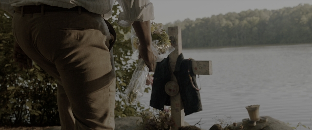 Wide shot frame from The Conjuring: The Devil Made Me Do It — standing, hand, shirt