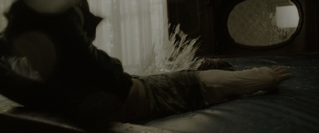 Wide shot frame from The Conjuring: The Devil Made Me Do It — room, bed, mirror