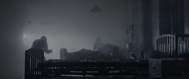 Wide shot frame from The Conjuring: The Devil Made Me Do It — book, standing, room