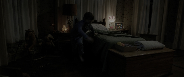 Wide shot frame from The Conjuring: The Devil Made Me Do It — sitting, room, table