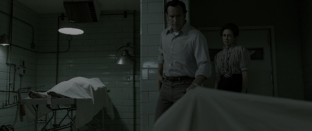 Wide shot frame from The Conjuring: The Devil Made Me Do It — standing, room, bed