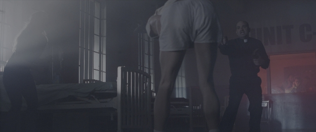 Wide shot frame from The Conjuring: The Devil Made Me Do It — standing, room, bed