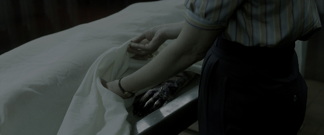 Wide shot frame from The Conjuring: The Devil Made Me Do It — bed, shirt, person