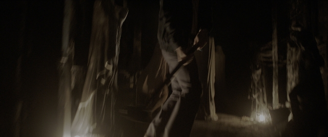 Wide shot frame from The Conjuring: The Devil Made Me Do It — standing, walking, night