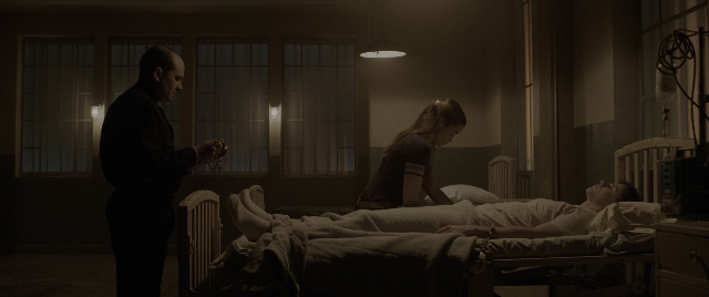 Wide shot frame from The Conjuring: The Devil Made Me Do It — standing, room, bed