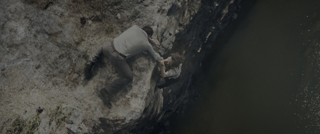 Wide shot frame from The Conjuring: The Devil Made Me Do It — standing, shirt, water