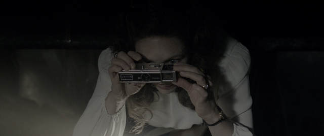 Wide shot frame from The Conjuring: The Devil Made Me Do It — face, camera, hair