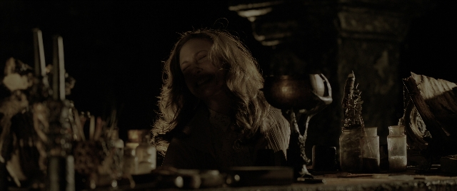 Wide shot frame from The Conjuring: The Devil Made Me Do It — sitting, table, hair
