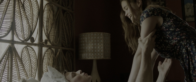 Wide shot frame from The Conjuring: The Devil Made Me Do It — room, bed, dress