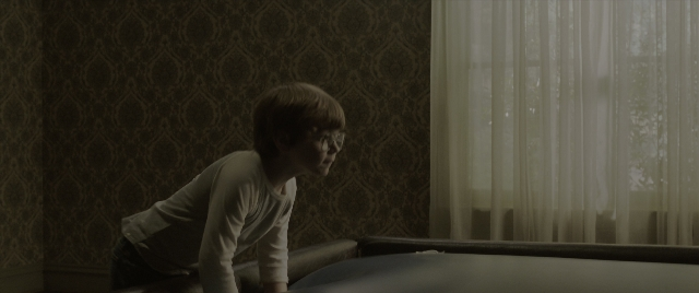 Wide shot frame from The Conjuring: The Devil Made Me Do It — standing, bed, shirt